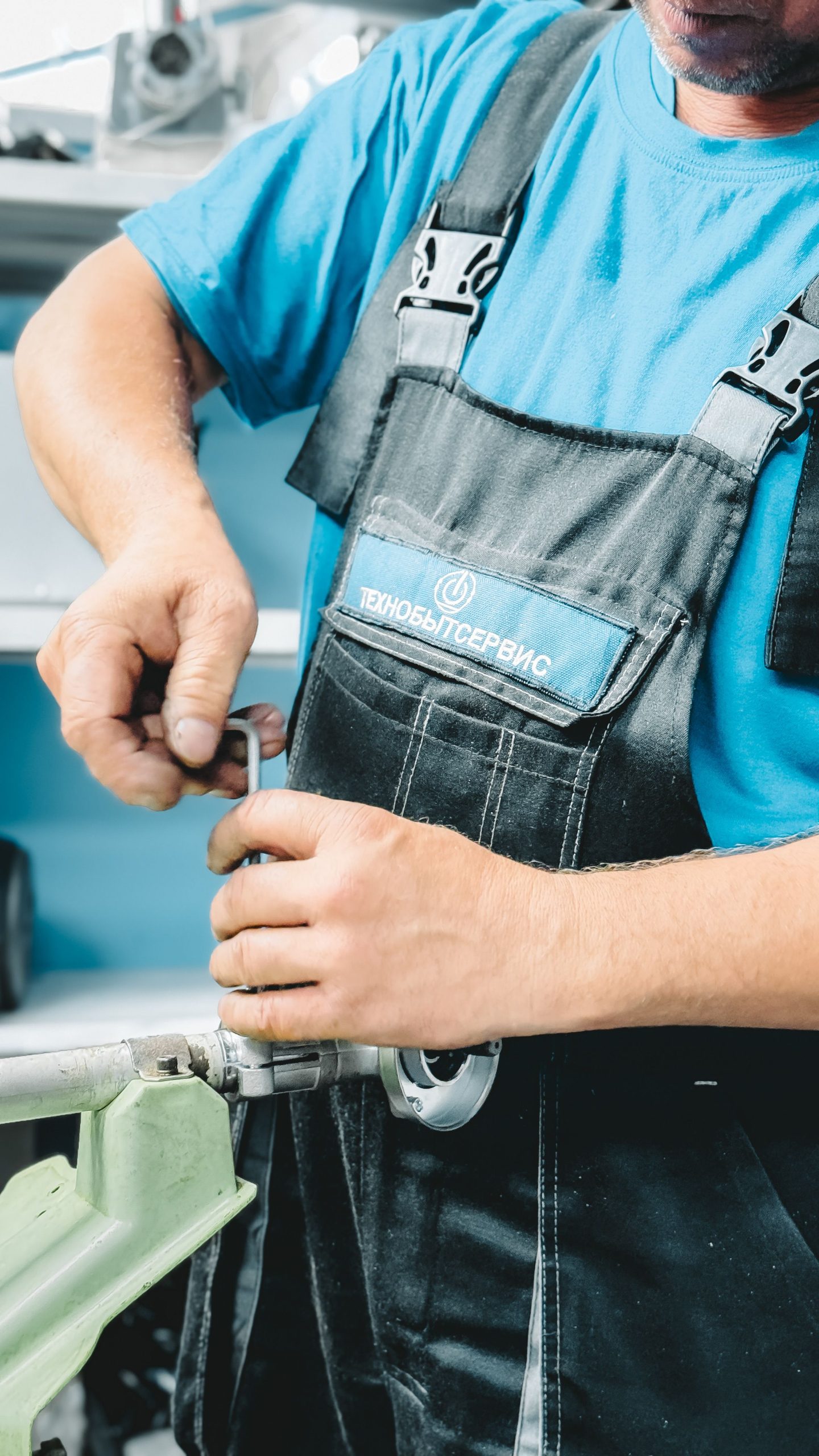 Plumber working on a pipe connection indoors.