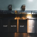 Stainless-steel sink and plumbing fixtures in a commercial kitchen.