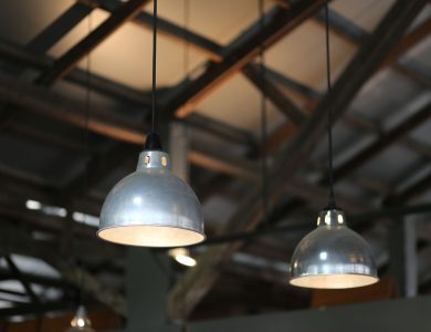 Close-up view of industrial hanging lamps in a warehouse setting.