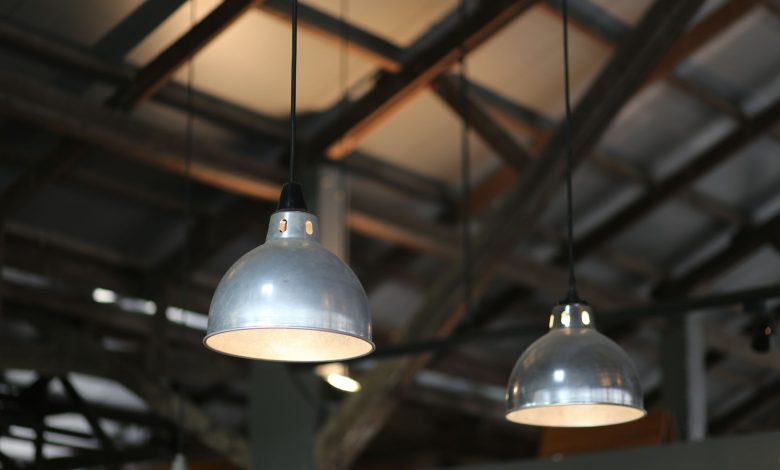 Close-up view of industrial hanging lamps in a warehouse setting.