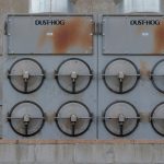Close-up of a Dust-Hog industrial dust collector with six rusty filtration units.