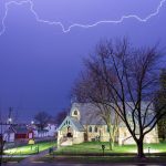 Lightning illuminates the night sky over a historic church in Wabasha, Minnesota, USA.