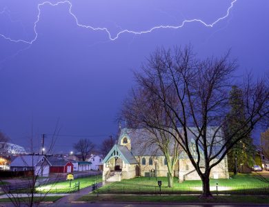 Lightning illuminates the night sky over a historic church in Wabasha, Minnesota, USA.