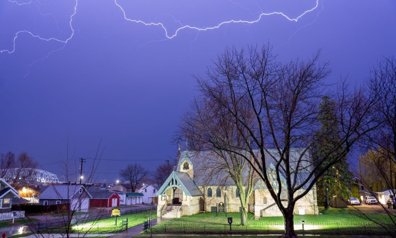 Lightning illuminates the night sky over a historic church in Wabasha, Minnesota, USA.