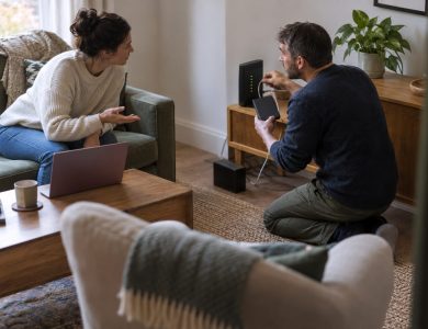 Two homeowners who work from home are in their terraced-house living room during a broadband outage,