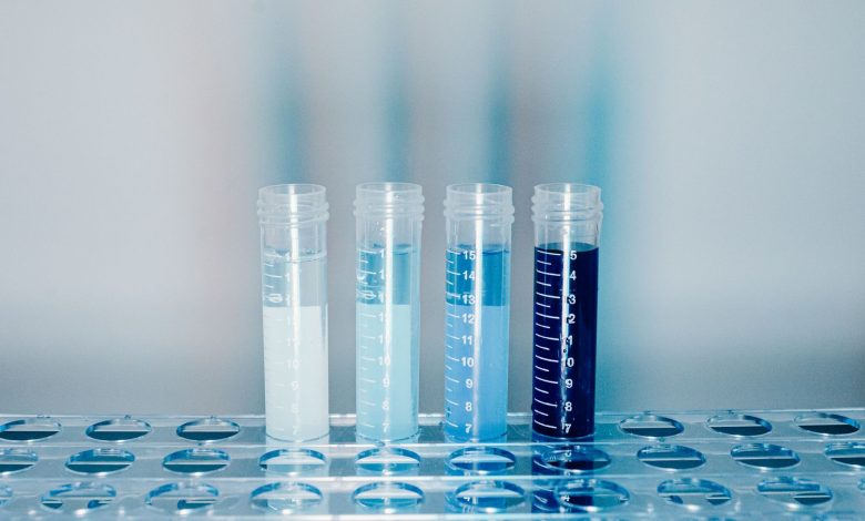 Close-up of test tubes filled with colorful liquids in a laboratory setting.