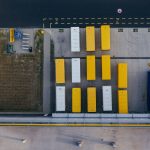 Aerial shot of colorful cargo containers at a warehouse in Poznań, Poland.