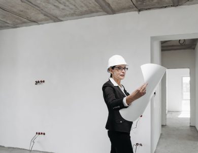 Professional female architect examining construction plans in a modern building