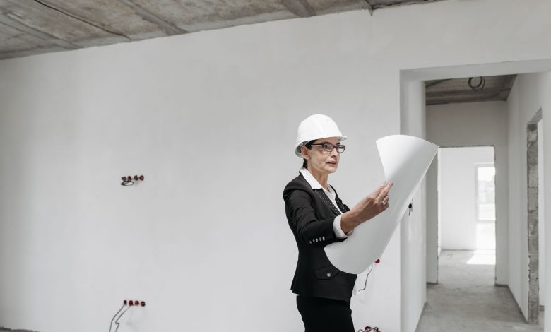 Professional female architect examining construction plans in a modern building