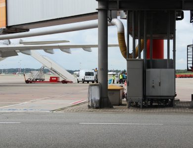 Airport scene depicting aircraft preparation on the tarmac with maintenance equipment.