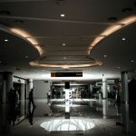 Sophisticated lobby with modern design and ambient lighting, featuring a spacious hallway.