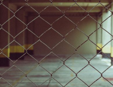 Blurred interior view through a chain link fence in industrial setting.