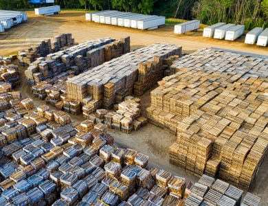 An aerial view of stacked wooden pallets in a warehouse yard, showcasing industrial storage arrangement.