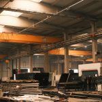 Interior view of an industrial warehouse with machinery and overhead cranes in Konya, Türkiye.