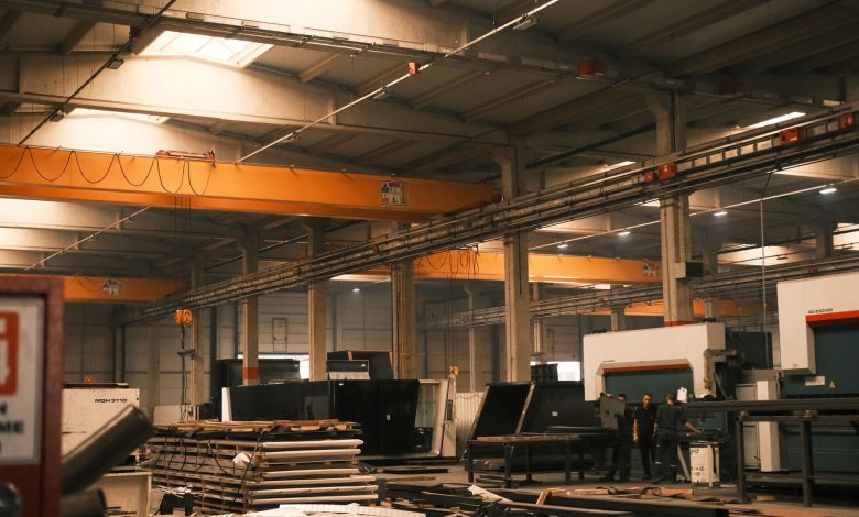 Interior view of an industrial warehouse with machinery and overhead cranes in Konya, Türkiye.