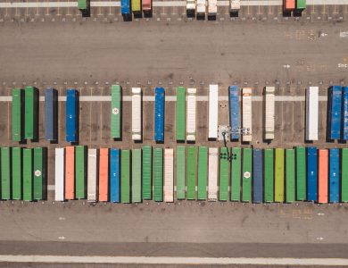 Top view of neatly arranged cargo containers in a shipping port, highlighting logistics and global trade.