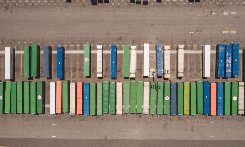 Top view of neatly arranged cargo containers in a shipping port, highlighting logistics and global trade.