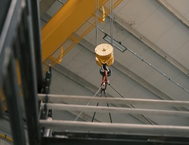 Close-up view of a yellow overhead crane hook in a warehouse in Konya, Türkiye.