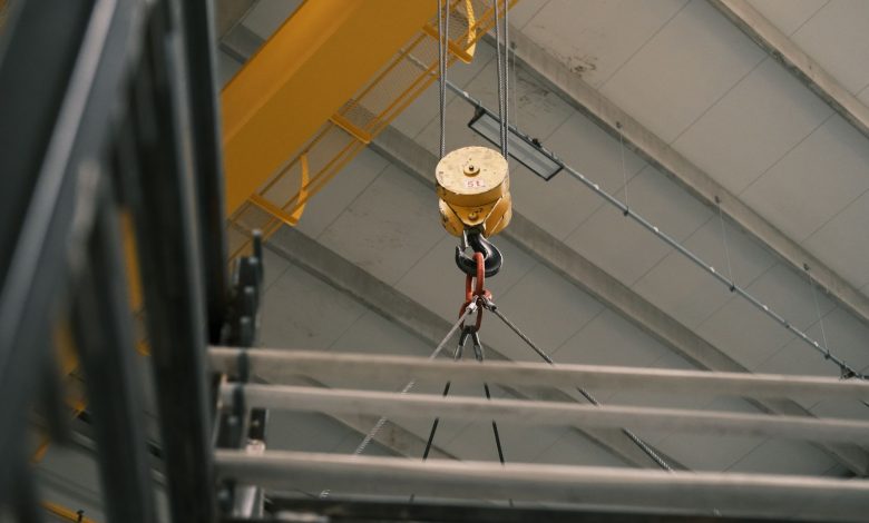 Close-up view of a yellow overhead crane hook in a warehouse in Konya, Türkiye.