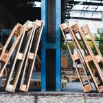 Close-up view of wooden pallets in an outdoor industrial warehouse setting.