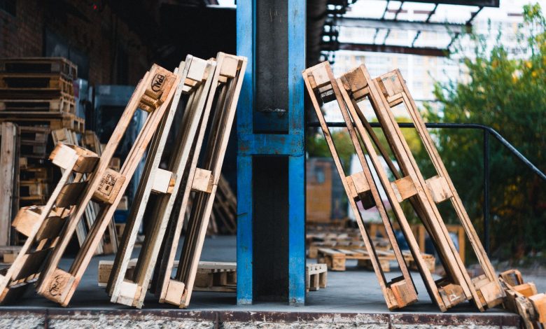 Close-up view of wooden pallets in an outdoor industrial warehouse setting.