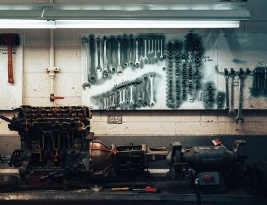 A well-organized workshop scene featuring tools and machinery on a workbench.